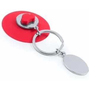 A red keyring with a circular charm and an additional smooth pendant attached, featuring a metal finish.