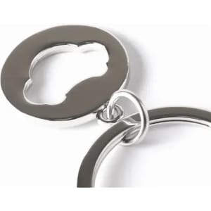 A silver keychain featuring a circular design with a cut-out shape resembling a car.