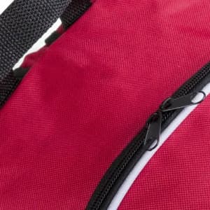 A red bag featuring a black zipper and straps, highlighting the textured fabric design.