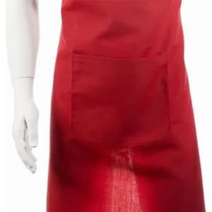 A red apron featuring a front pocket and displayed on a white, mannequin-style hand.
