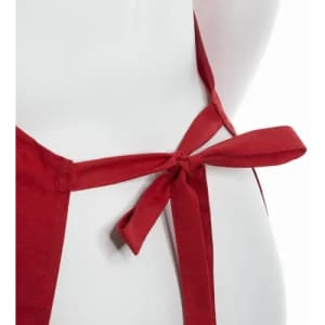 A red apron featuring a tied bow at the back. The fabric appears smooth and durable.
