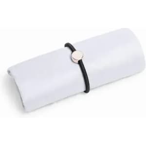 A rolled white cloth secured with a black elastic band and a metallic disc.