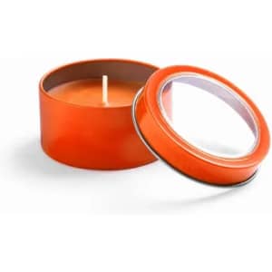 An orange candle in a round tin, with the lid slightly removed, revealing the wick inside.