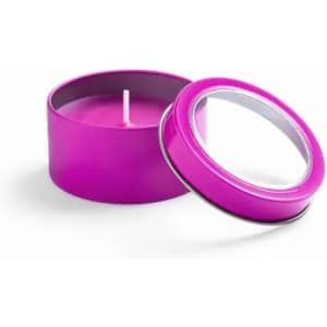 A pink tin candle with a removable lid, showcasing a bright purple wax interior.
