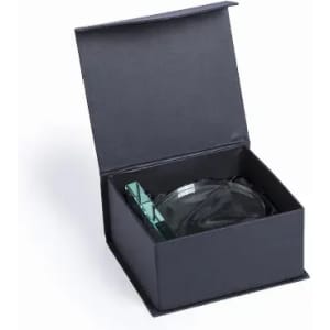 A gift box containing a glass with a green accent. The box is black and features a simple, elegant design.