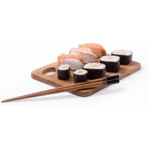 A wooden platter holding various types of sushi, accompanied by chopsticks.