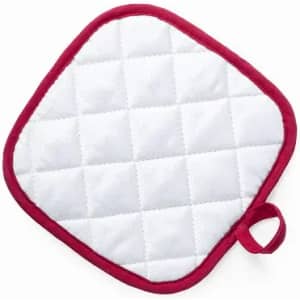 A white quilted pot holder with a red border and a loop for hanging.