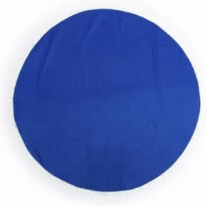 A round blue cloth with a fringed edge, displaying a smooth and flat surface.