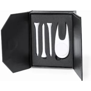 A golf accessory set including three white tees and a divot tool, presented in a black box with foam padding.