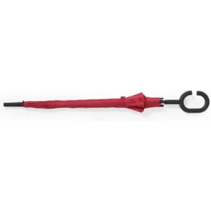 A red umbrella with a black handle, fully closed, featuring a curved hook design.