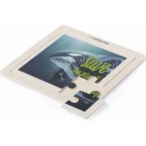 A puzzle piece featuring an image of a whale with green text, set against a light-coloured background.