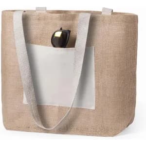 A tote bag made of natural burlap with a cream pocket and grey straps, featuring a pair of sunglasses inside.