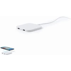 A white square power bank with two USB ports and a charging cable, placed next to a smartphone.