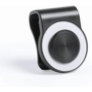 A black and silver drink bottle attachment with a circular design and textured surface. It has a small attached clip.