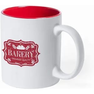 A white mug with a red interior featuring a decorative red logo that reads "Bakery Premium Quality."