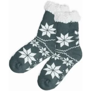A pair of dark green socks with white snowflake patterns and a fluffy white cuff. The socks have a knitted texture.