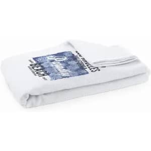 A folded white towel featuring a blue and white design. The towel has a logo and text printed on it.