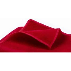 A red fabric blanket folded to display its soft texture. The blanket features a smooth edge and vibrant colour.