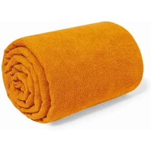A rolled orange towel displayed on a white background, featuring a soft, textured surface.