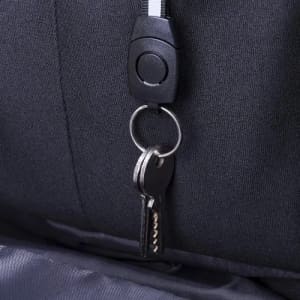 A black zipper with a circular pull tab and a keyring attached, featuring two keys.