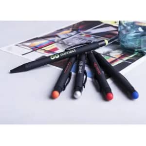 A collection of black pens with coloured tips (red, blue, orange, white) arranged on a printed page.