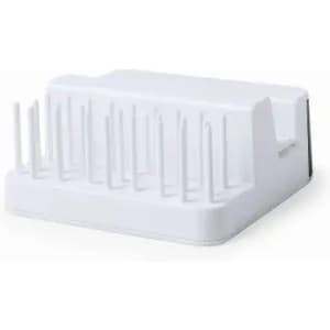 A white product with multiple spikes on top, designed for holding or drying items. It has a smooth base and edges.