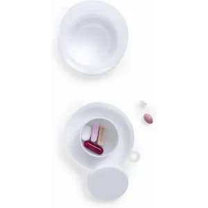 A capsule container with a lid, featuring several colourful pills inside and one pill outside the container.