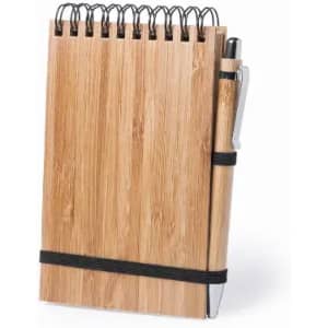 A bamboo notebook with a spiral binding, featuring a pen secured by a black elastic band.
