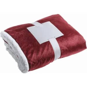 A plush blanket in burgundy and white, neatly folded and secured with a tag.