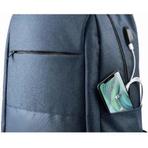 A backpack in navy blue with a front pocket and a smartphone plugged into a charging cable.