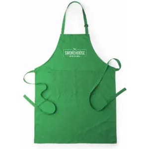 A green apron featuring a logo at the top and waist ties for secure fastening.