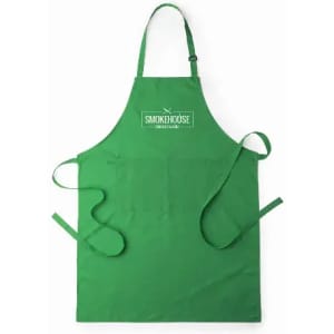A green apron featuring pockets and a logo at the top. It has ties on the sides for fastening.
