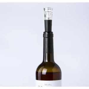 A drink bottle with a dark brown body and a clear top, featuring a black neck and a transparent spout.