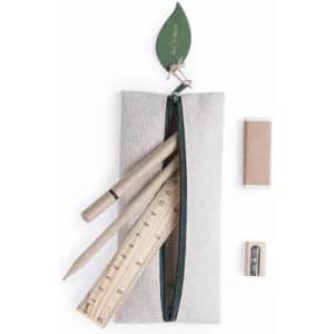 A pencil case in light grey fabric, containing wooden pencils, a ruler, an eraser, and a sharpener, topped with a leaf design.