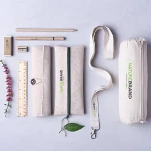 A collection of stationery items, including pouches, a ruler, pencils, and a strap, in natural fabric colours.