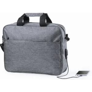 A grey laptop bag with dual handles and a front pocket, featuring a charging cable connected to a smartphone.