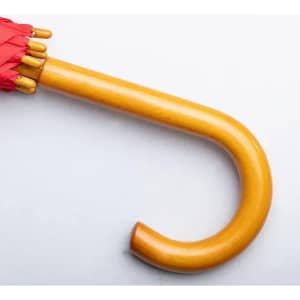 A red umbrella with a golden wooden handle, featuring a curved grip at the end.