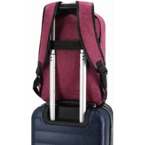 A maroon backpack with adjustable straps resting on a blue suitcase, featuring a logo on the fabric.