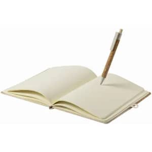 An open notebook with blank pages and a pen resting inside, featuring a natural cork design.