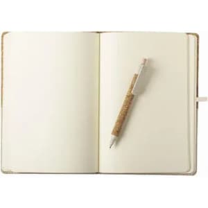 An open notebook with blank pages and a cork-covered pen resting on the right side.