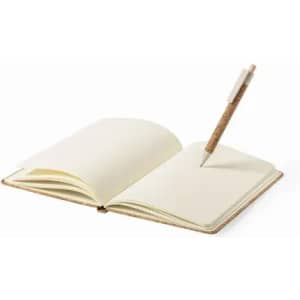 An open notebook with blank pages and a pen resting on it. The notebook has a brown cover, and the pen features a cork grip.