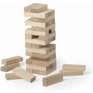 A stack of wooden blocks in natural tones with several blocks scattered on the ground around it.