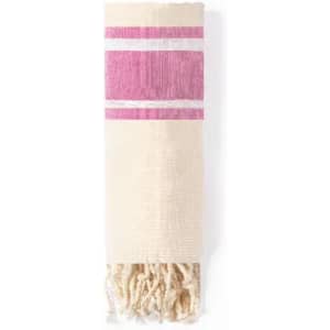A woven towel featuring a cream base with pink stripes and tassels at one end.
