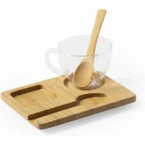 A bamboo tray featuring a clear glass cup and a wooden spoon, arranged neatly on the surface.