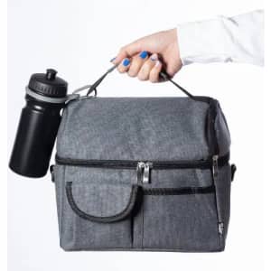 A grey insulated bag held by a hand, complete with a black drink bottle attached.