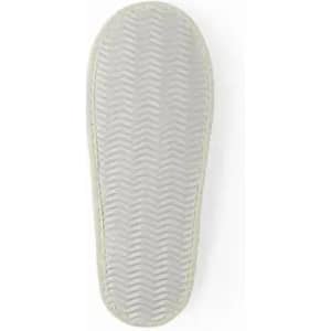 A shoe sole with a textured, zigzag pattern in light grey, featuring a smooth edge.