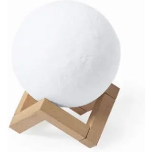 A white spherical object displayed on a wooden stand. The stand features a zigzag design.