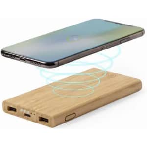 A wireless charger made of bamboo, with a smartphone floating above it, demonstrating charging capability.
