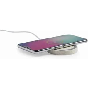 A wireless charging pad with a circular concrete base, supporting a sleek smartphone on top.
