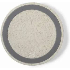 A round, speckled beige product with a dark grey ring and a logo in the centre.